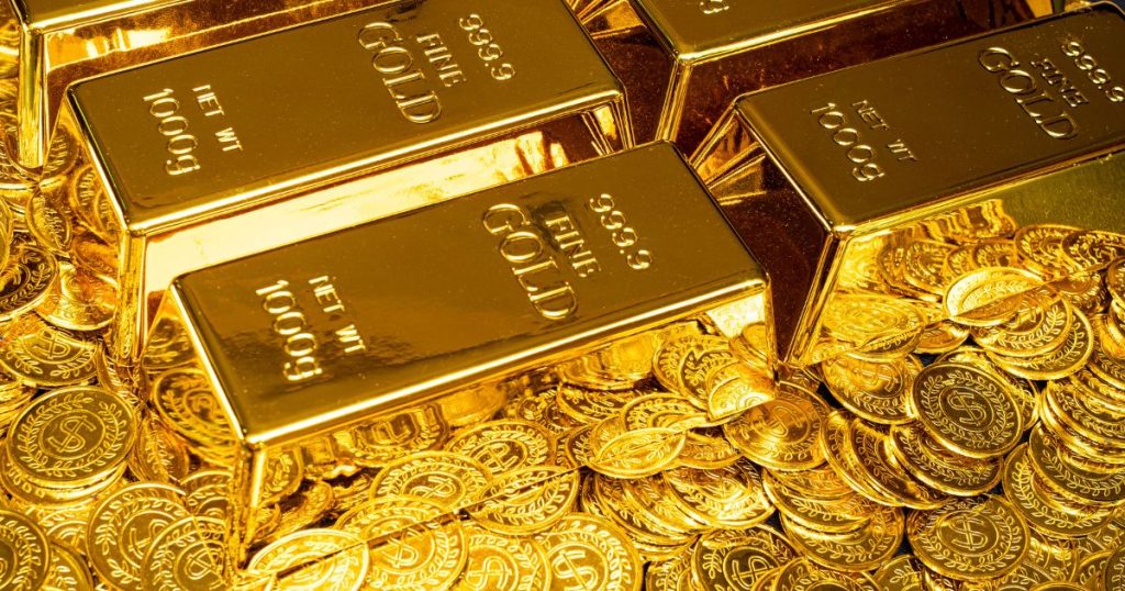 Gold bars and coins, a symbol of wealth and prosperity, gleam in this image.