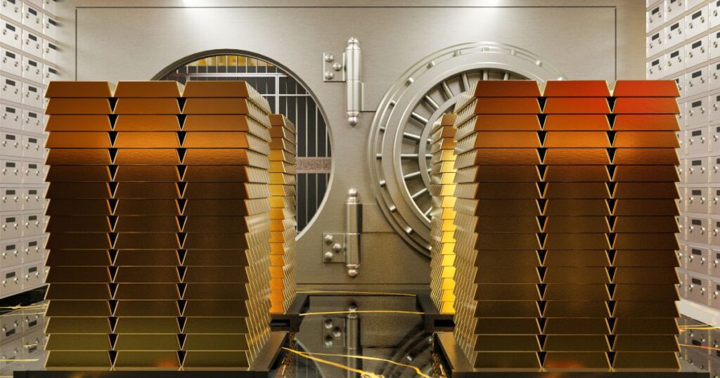 Gold bars neatly stacked in a secure vault, gleaming with their precious shine. A symbol of wealth and security.