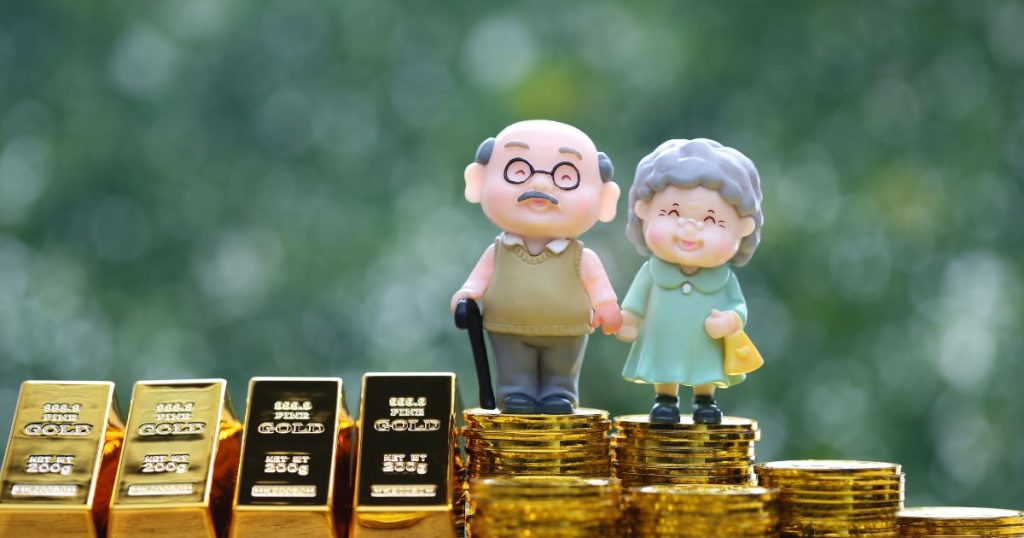 Golden couple figurines on gold bars - symbolizing wealth and prosperity.