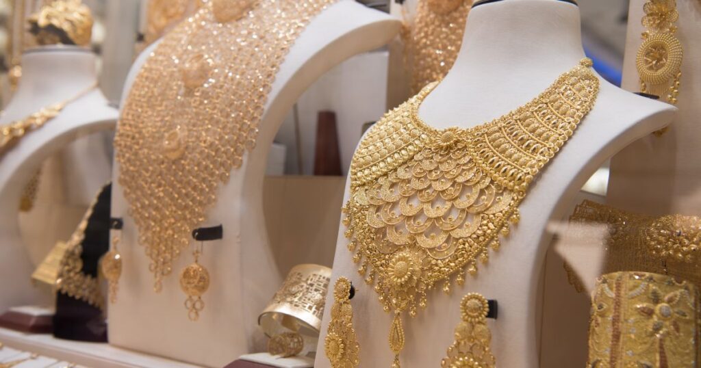 Gold jewelry on display in a store: A dazzling assortment of gleaming gold necklaces, bracelets, and rings showcased elegantly.