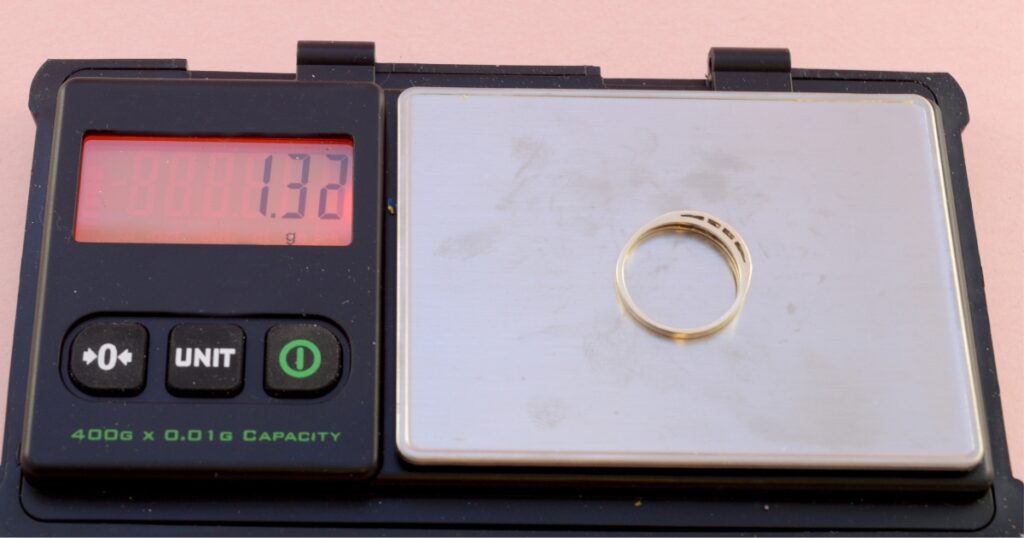 a gold ring on a scale